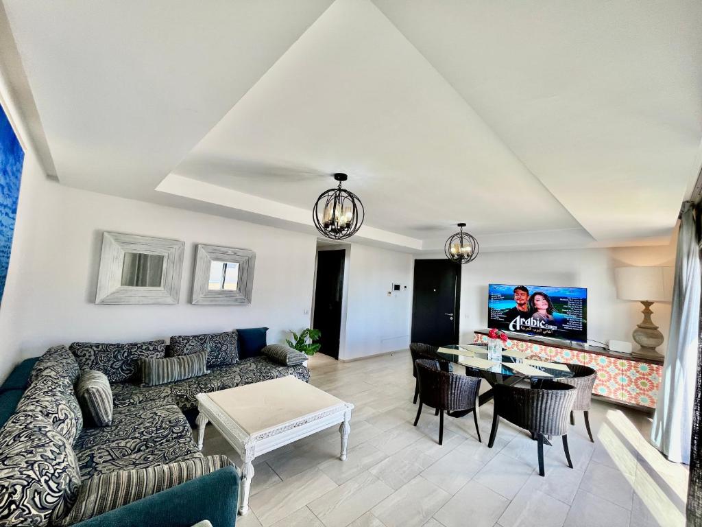 a living room with a couch and a table at Atlantic View Duplex Tawenza Bay in Taghazout