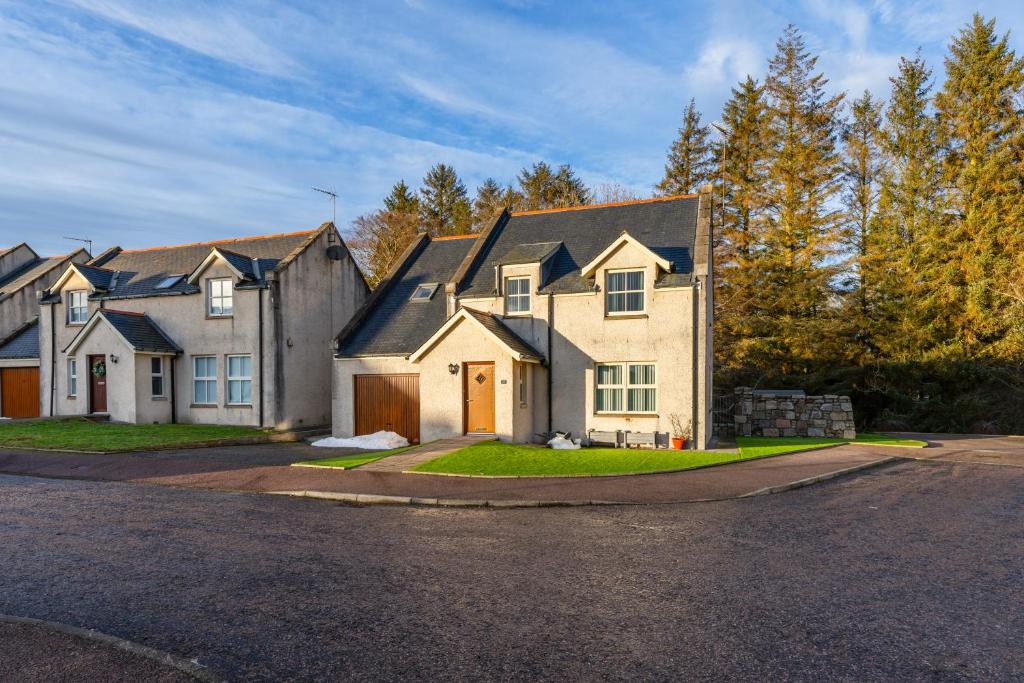 a house on a street with a driveway at Abbey View in Old Deer