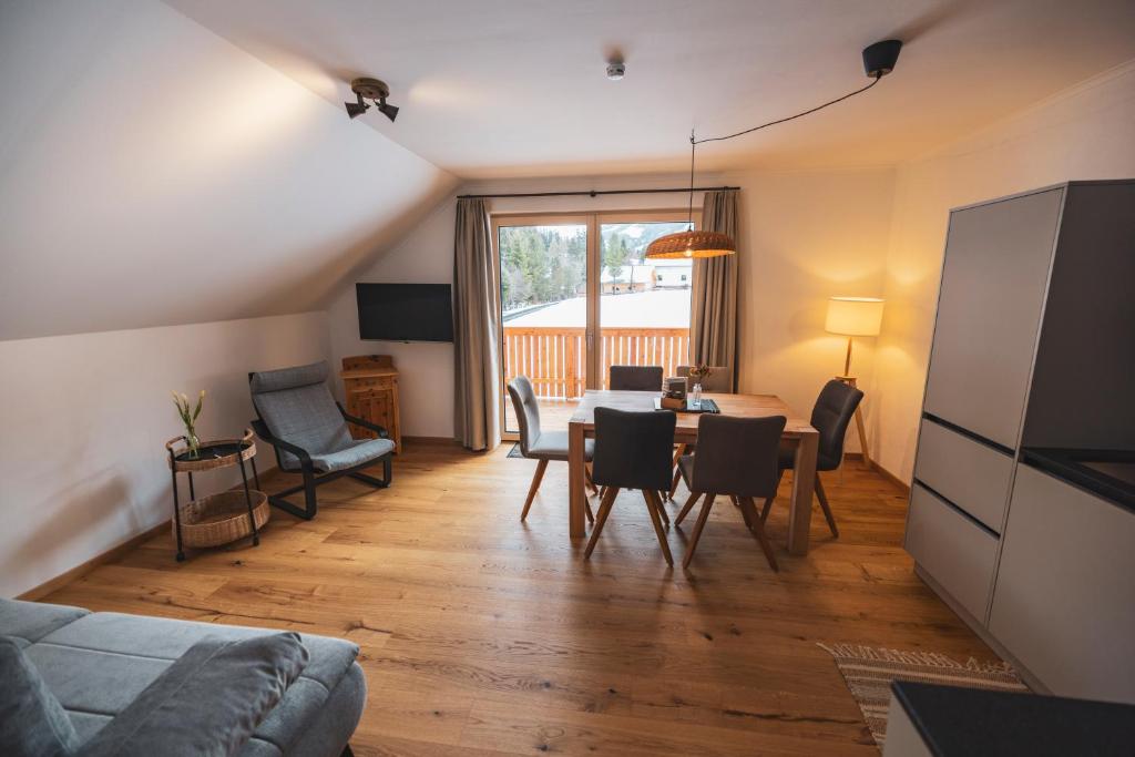 a living room with a couch and a table and chairs at Der Sagbauer in Donnersbachwald