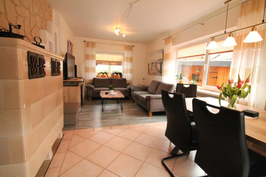 a living room with a couch and a table at Haus Clara in Husby