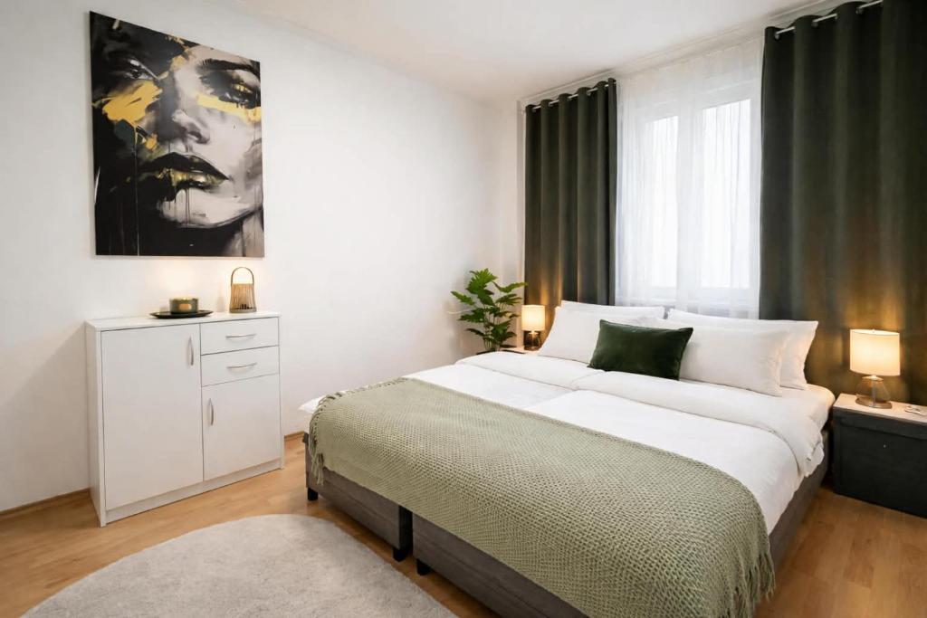 a bedroom with a bed and a large window at Apartman Cañas Zelená Víla in Rimavská Sobota