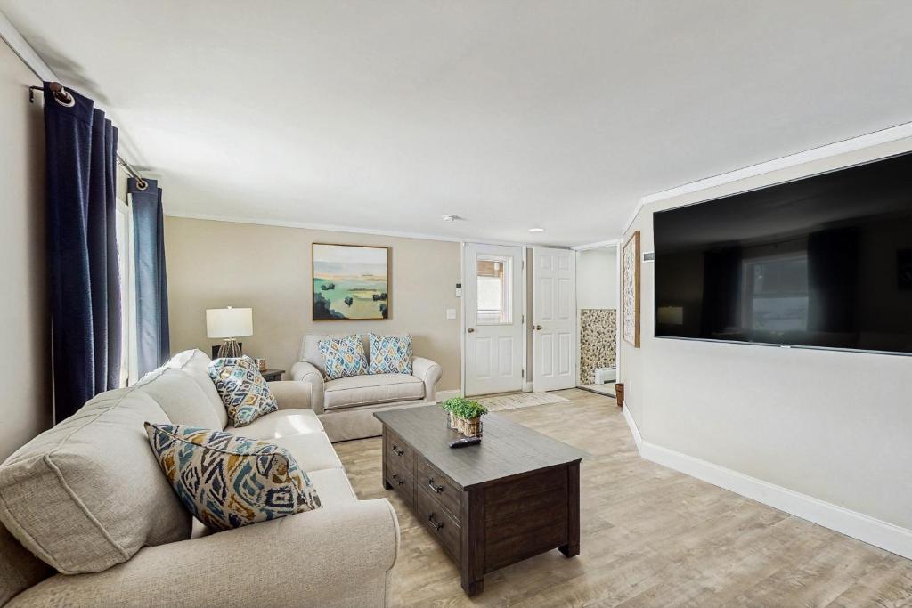 a living room with a large flat screen tv at 12 Mi to Lake George! Quiet Adirondack Escape in Fort Ann
