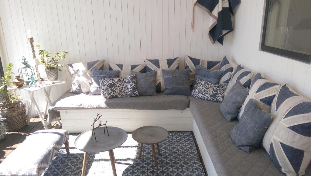 a living room with a couch with blue pillows at Utsikten i Bua in Kungshamn