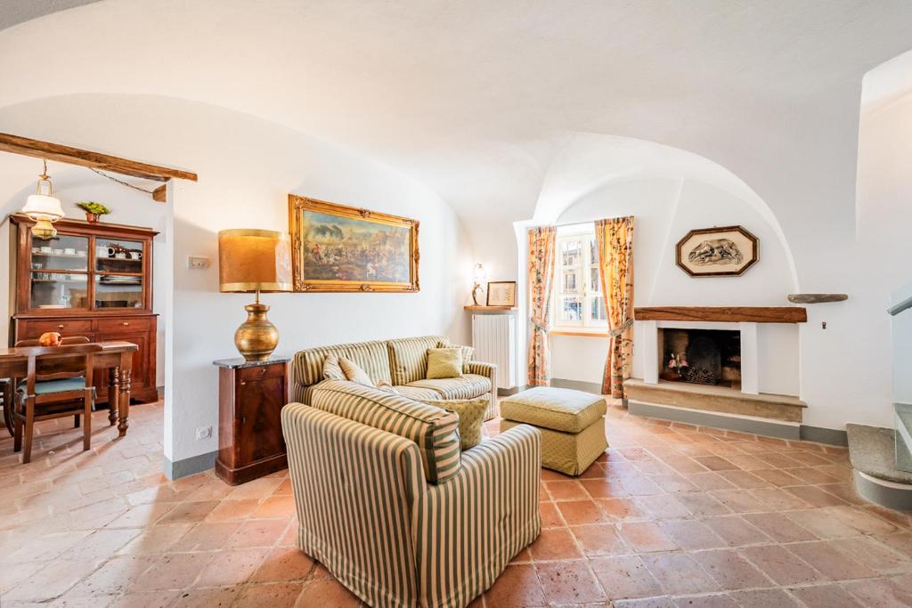 a living room with a couch and a fireplace at La Meridiana in Carrù