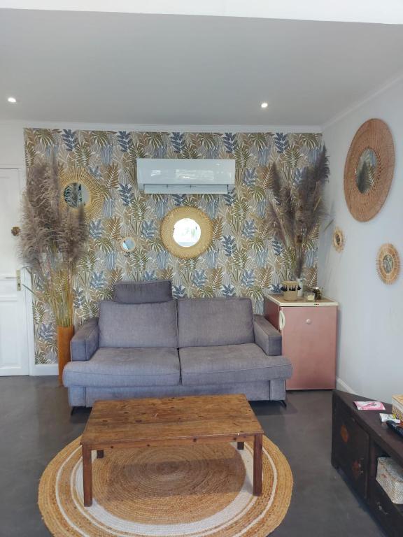 a living room with a couch and a coffee table at La splendide Coralline in La Saline Les hauts 