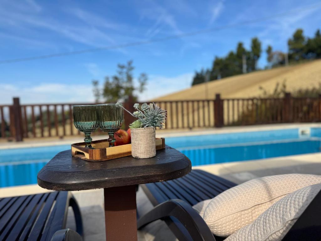 a table with a lamp and fruit on it next to a pool at Respiro di Tramonto in Montegranaro