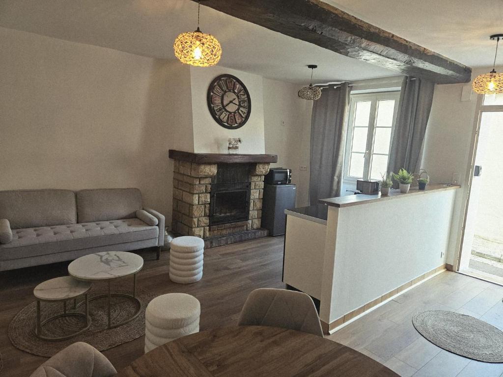 a living room with a couch and a fireplace at Chez collette in Chablis