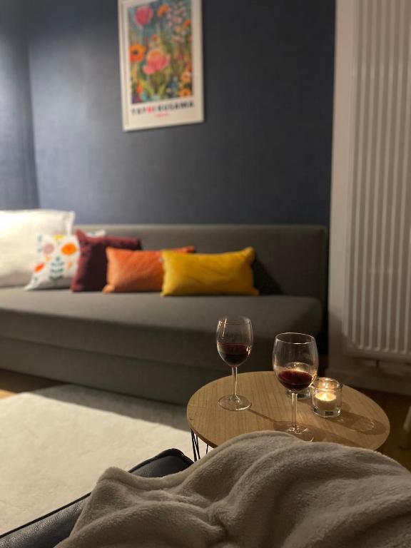 two glasses of wine on tables in a living room at Coquelicot in Waulsort