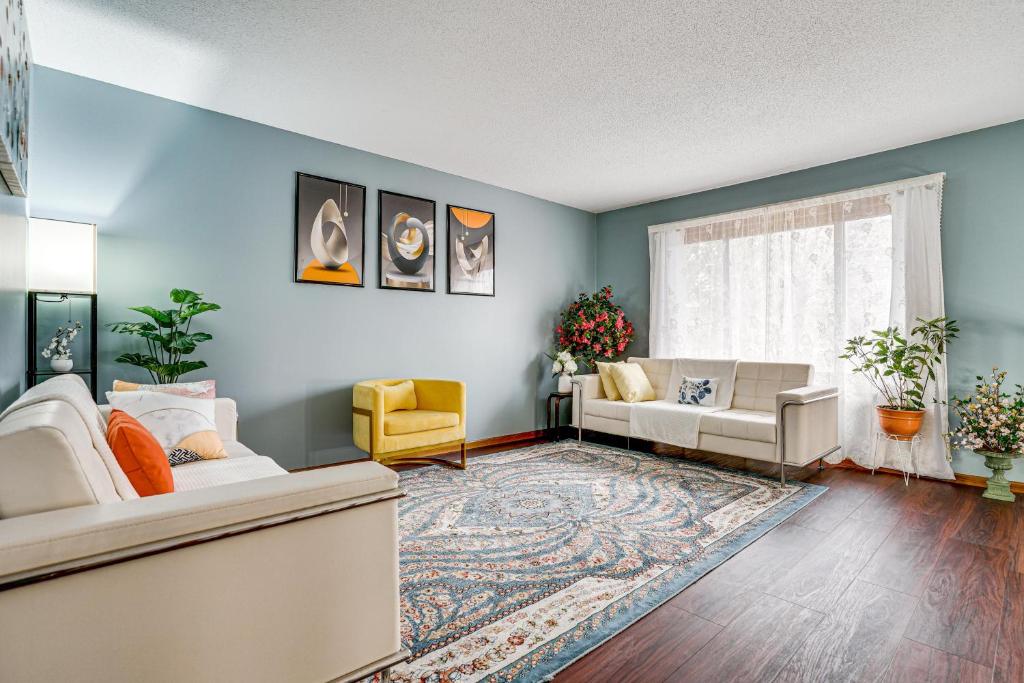 a living room with blue walls and a couch at Deck & Outdoor Dining! Spacious St Paul Getaway in North Saint Paul