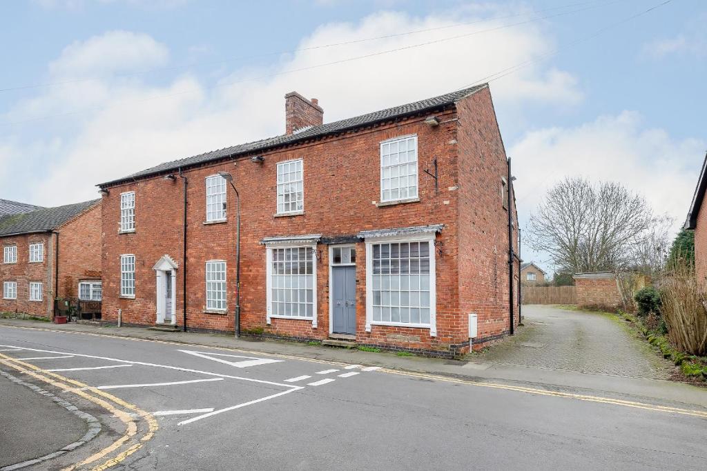 an old red brick building on the side of a street at Hambleton House in Derby