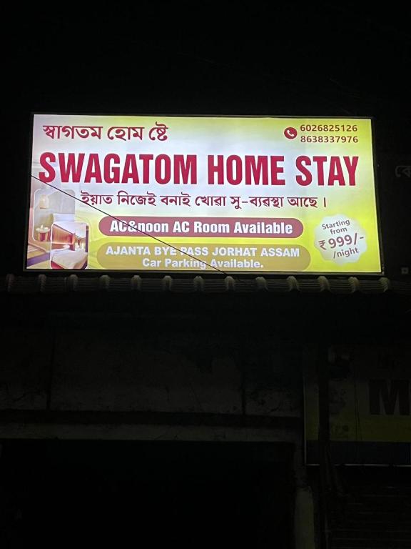 a sign for a vacation home stay on a bus at swagatom Homestay in Jorhat