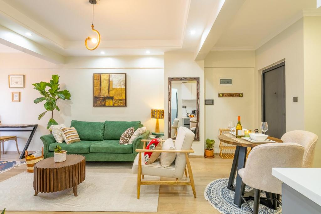 a living room with a green couch and a table at Kikao-Marina Bay in Nairobi