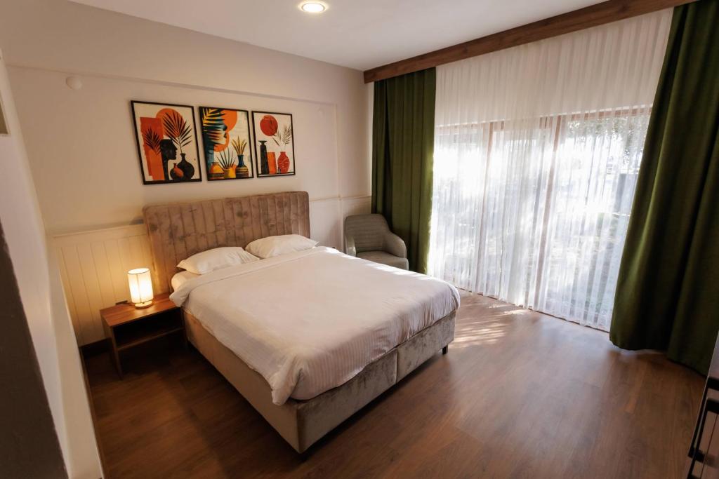 a bedroom with a large bed and a window at TUNA OTEL in Gelibolu