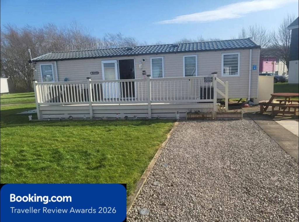 a mobile home with a porch and a deck at MLR at Craig Tara Bay View in Ayr