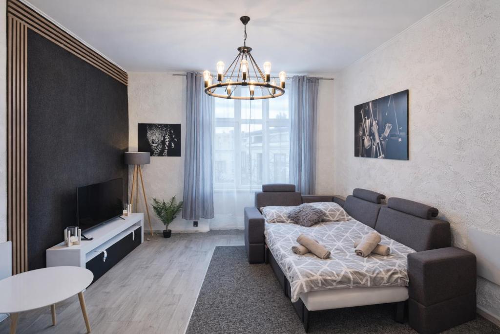 a bedroom with a bed and a couch and a table at Apartament Fantazja in Przemyśl