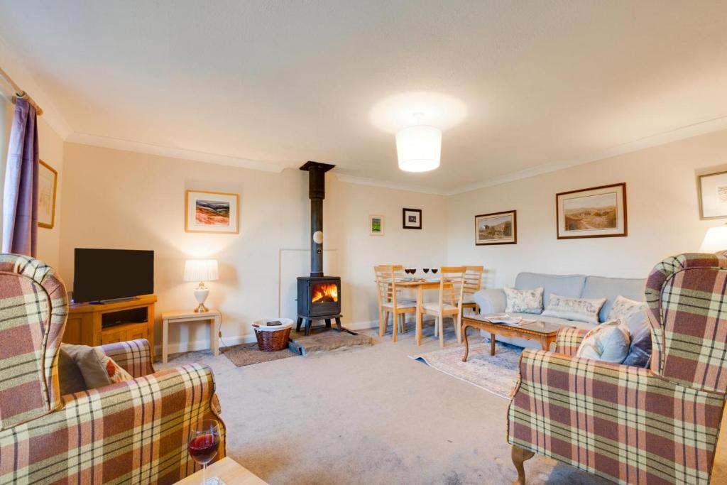a living room with two couches and a fireplace at 2 Bed in Askrigg oc-ds1019 in Askrigg