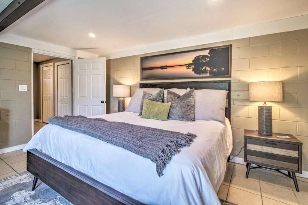 a bedroom with a large bed in a room at Charming Lakefront Apt Near Disney in Orlando