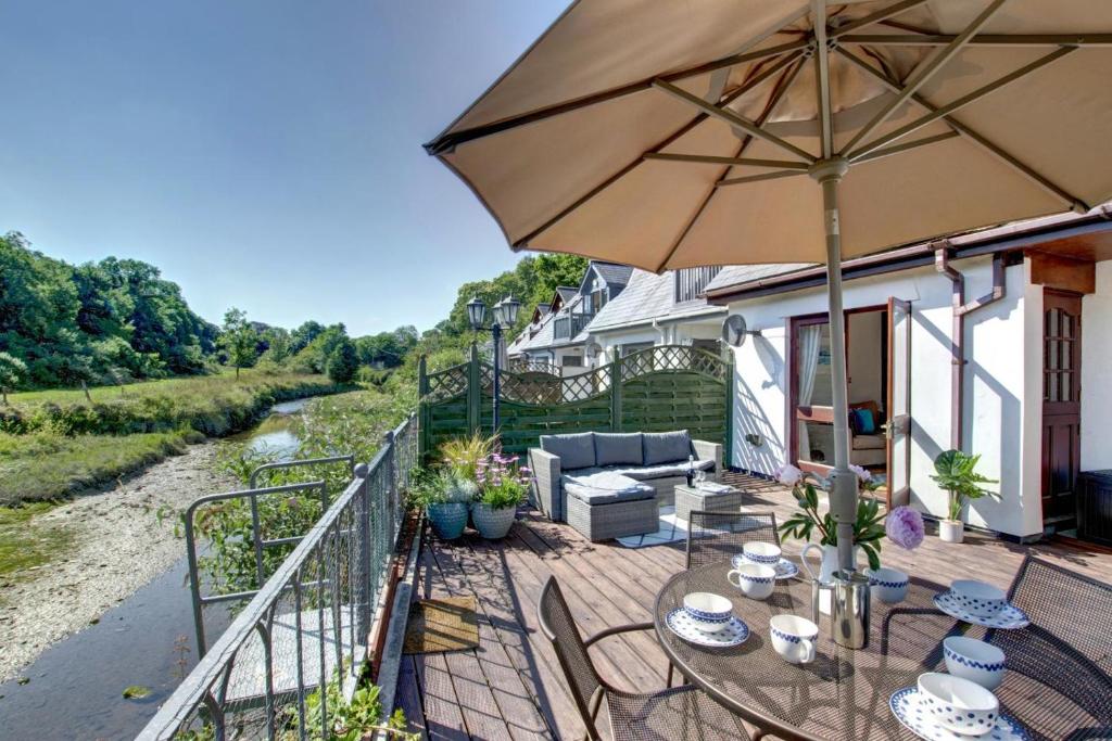 a patio with a table and an umbrella at 2 Bed in Little Petherick oc-p00635 in Little Petherick