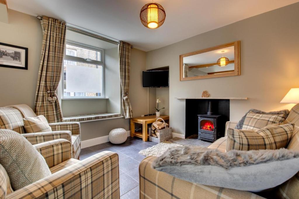 a living room with couches and a fire place at 2 Bed in Hawes oc-ds937 in Hawes