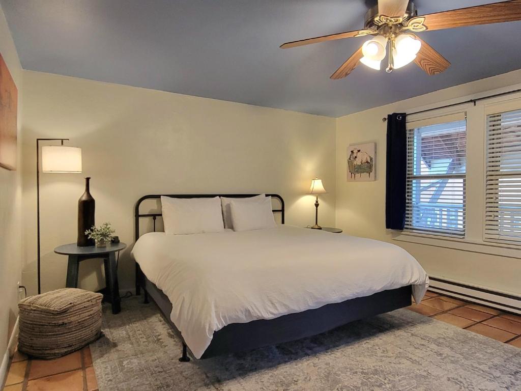 a bedroom with a bed and a ceiling fan at La Veta Inn in La Veta