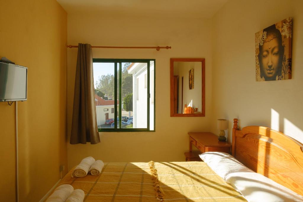 a bedroom with a bed with towels on it at La Palma Hostel by Pension Central in Fuencaliente de la Palma