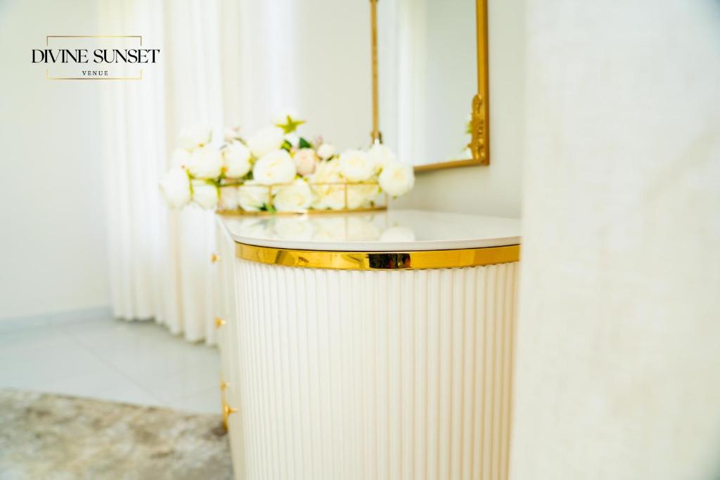 a white counter with a bowl of white flowers on it at Olifile Boutique Hotel & Restaurant in Midrand