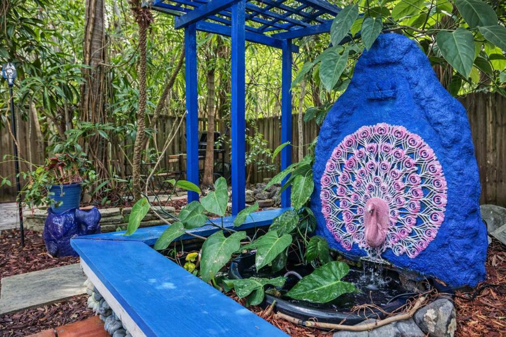 a blue bench with a plant in a garden at Garden botanical Villa with jacuzzi in Hollywood