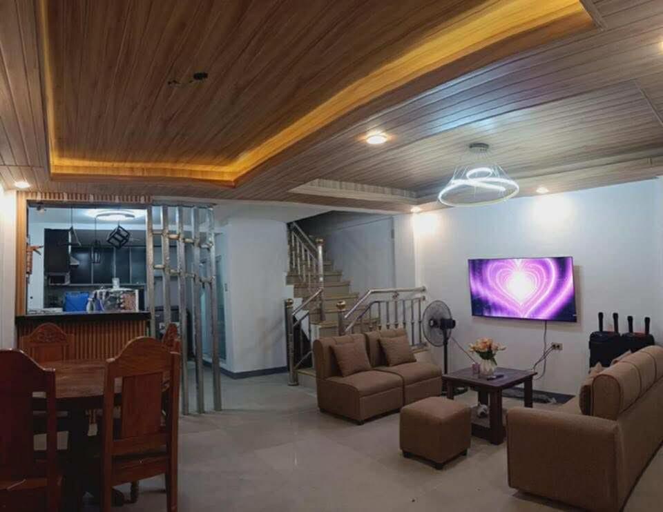 a living room with a couch and a tv at Caperina del Casa-Rental in Naic