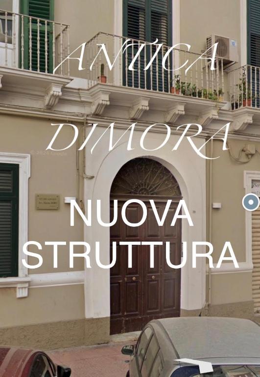 a building with a door and a car parked in front at Antica Dimora in Taranto