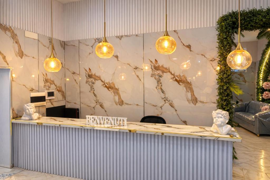 a lobby with a reception counter with lights at Guest House Partenope in Naples