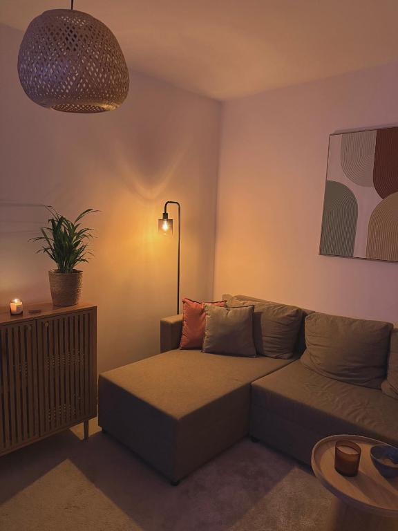 a living room with a couch and a lamp at Cozy Apartment - Netflix & Free parking in Žilina