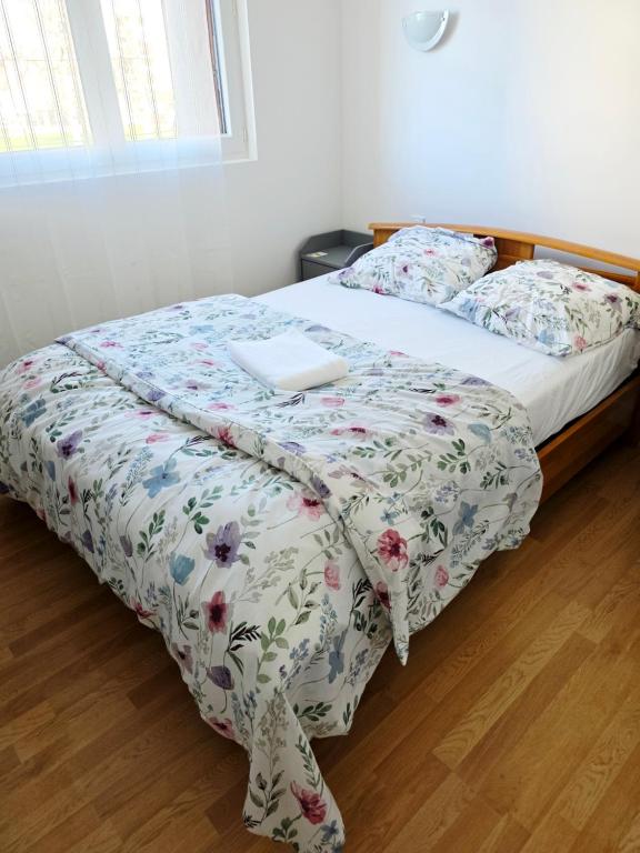 a bed with a blanket with a laptop on it at Chambre 1 in Toulouse