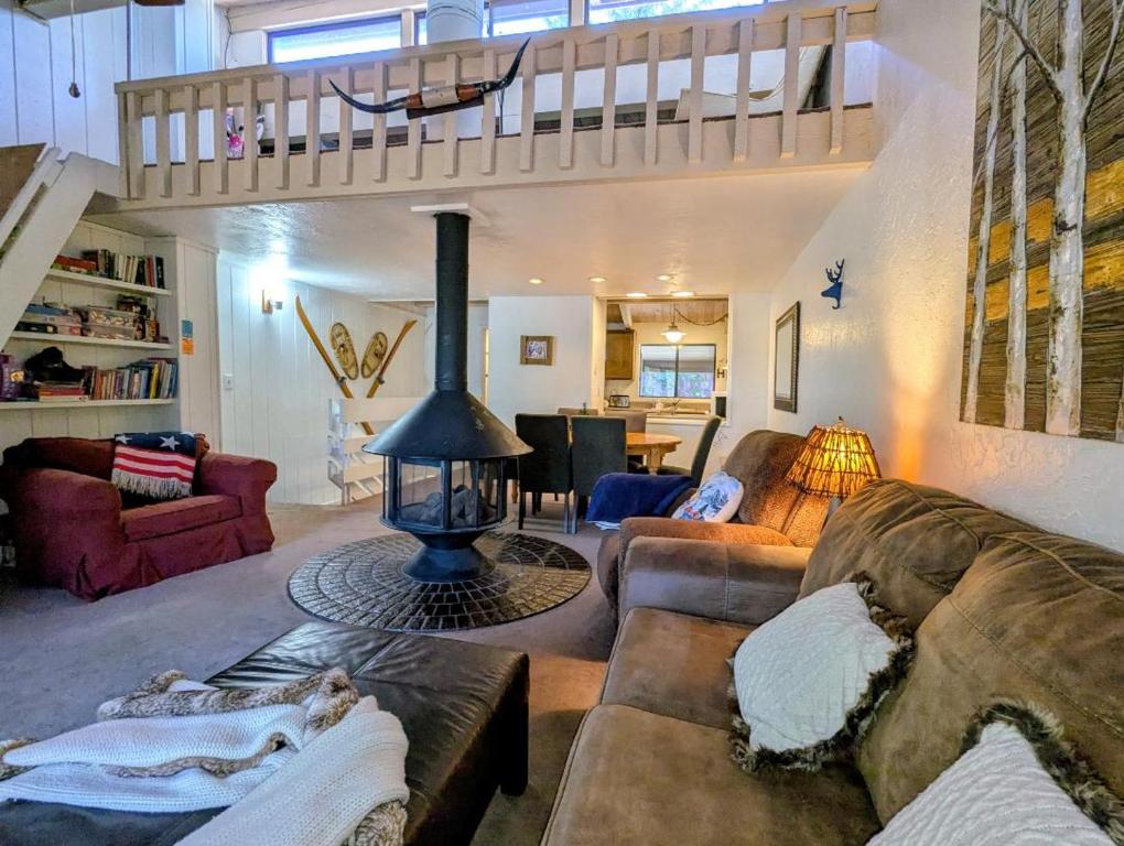 a living room with a couch and a fireplace at Snow Summit Townhouse Unit 09 in Big Bear Lake