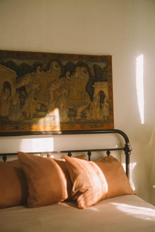 a painting above a bed with pillows in a bedroom at Object Hotel 1BR Room 3A in Bisbee