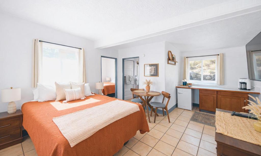 a hotel room with a bed and a table at Dam Site Lodging in Truth or Consequences