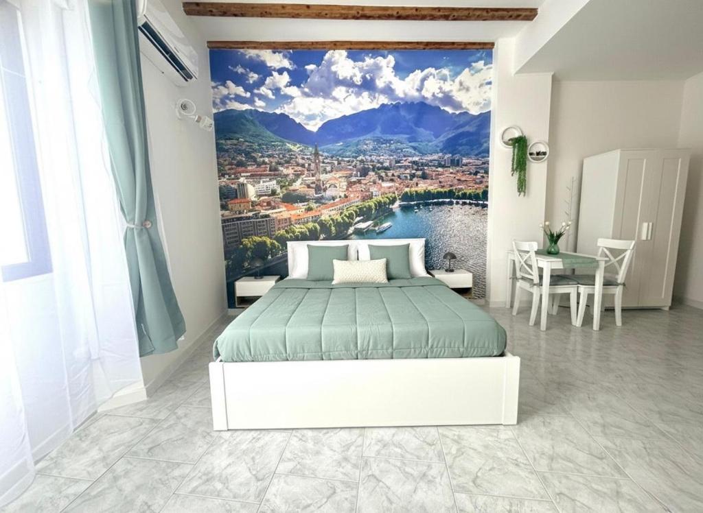 a bedroom with a large painting on the wall at Lecco's heart! Centro Lecco - A due passi dal lago - Moderno e luminoso in Lecco