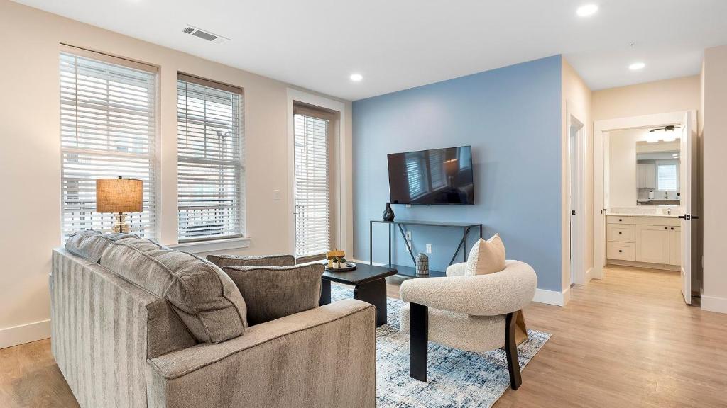 a living room with a couch and a chair at Landing Modern 2BD Gym Pool in Cornelius