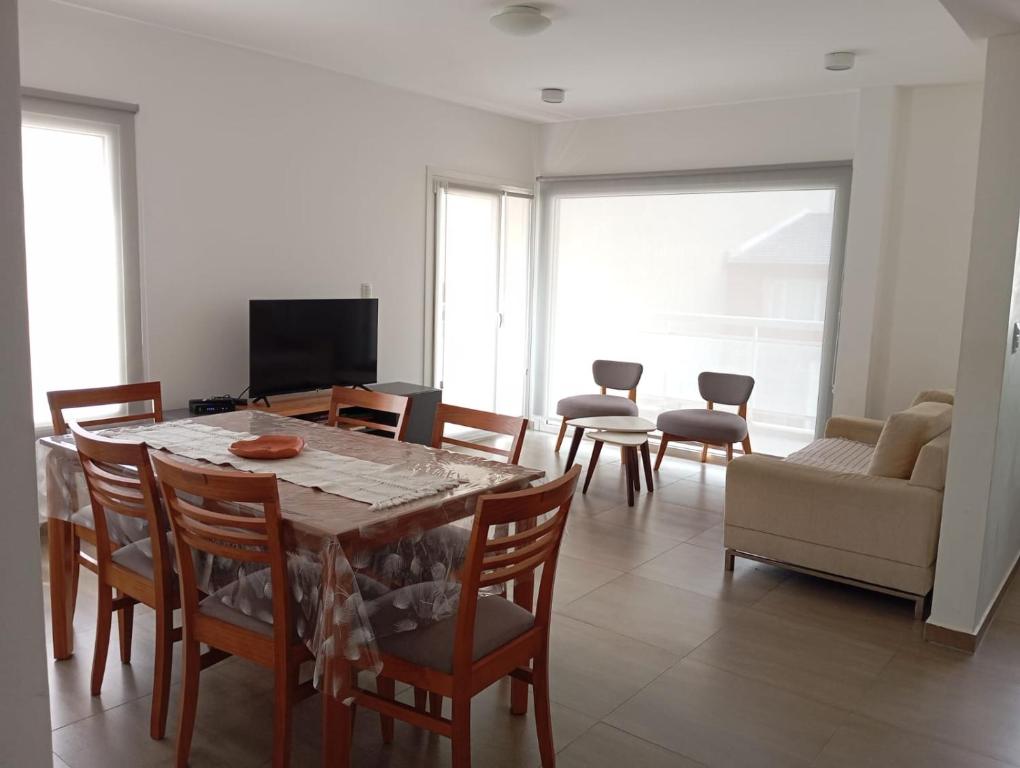a living room with a dining room table and chairs at Malaika in Puerto Madryn