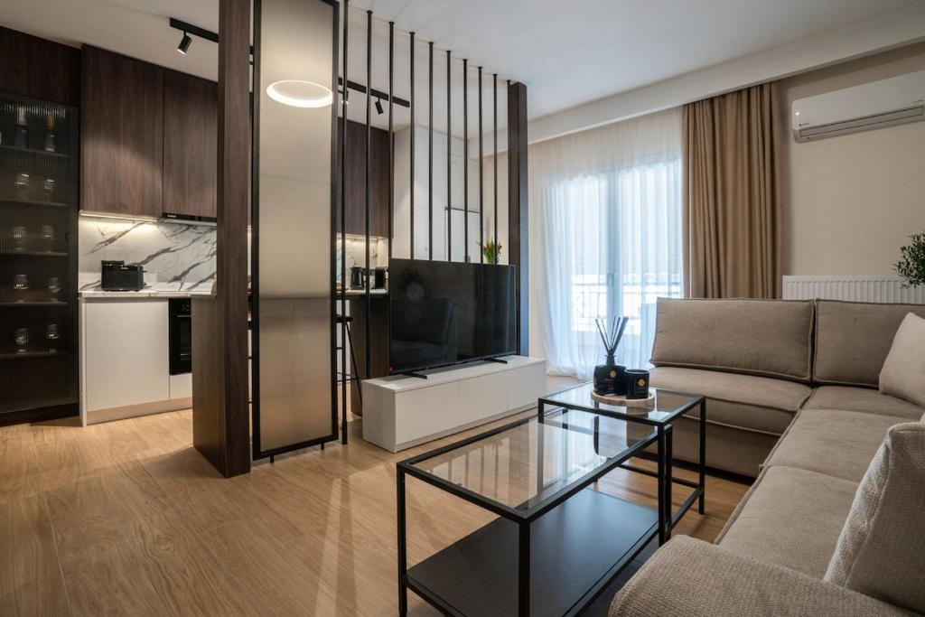 a living room with a couch and a television at The Fourth - Where Four Becomes Home in Larisa