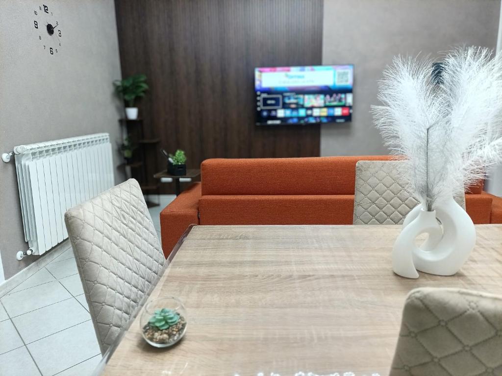 a dining room with a table and a couch at La Capaciota in Capaci