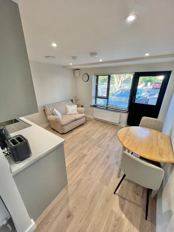 a living room with a table and a couch at Ballyaghran Stay in Portstewart