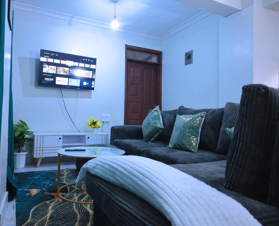 a living room with a couch and a table at Lola Homes Thika in Thika