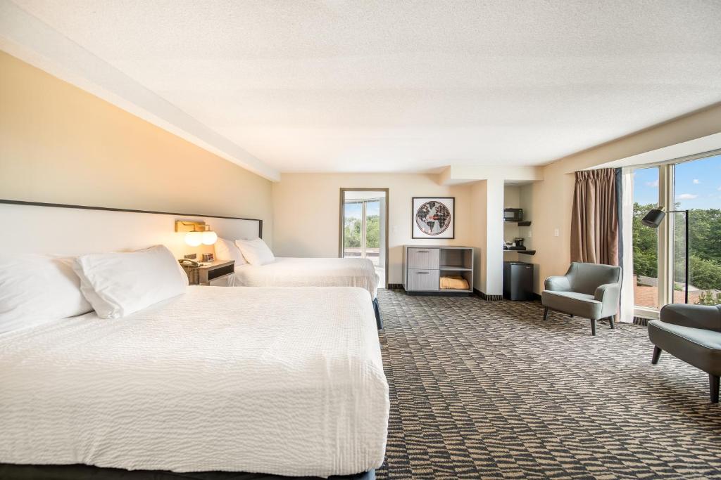 a hotel room with two beds and a window at Ramada Plaza by Wyndham Niagara Falls in Niagara Falls