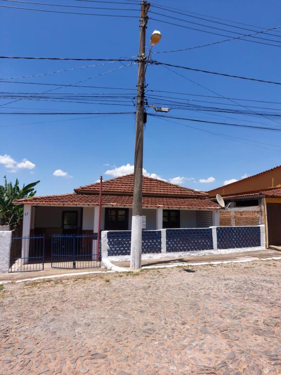 a house with a telephone pole in front of it at Contos de Alice in Tiradentes