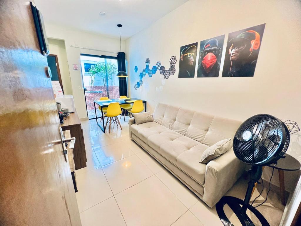 a living room with a couch and a table at Residencial Mª Do Bonfim - 5km Aeroporto JK in Brasília