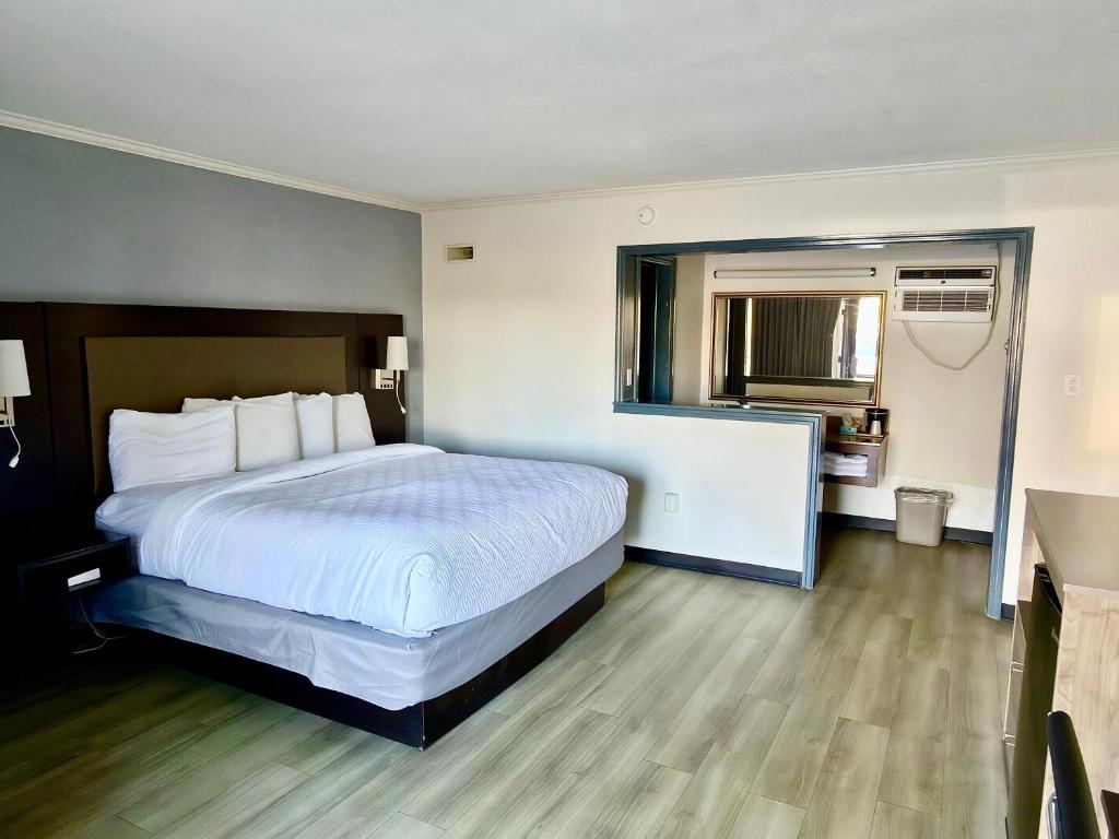 a hotel room with a bed and a bathroom at Budget Inn Conway in Conway