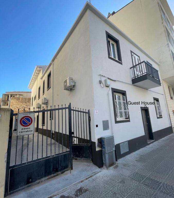 a guest house with a fence in front of it at Domus de janas 2 in Alghero