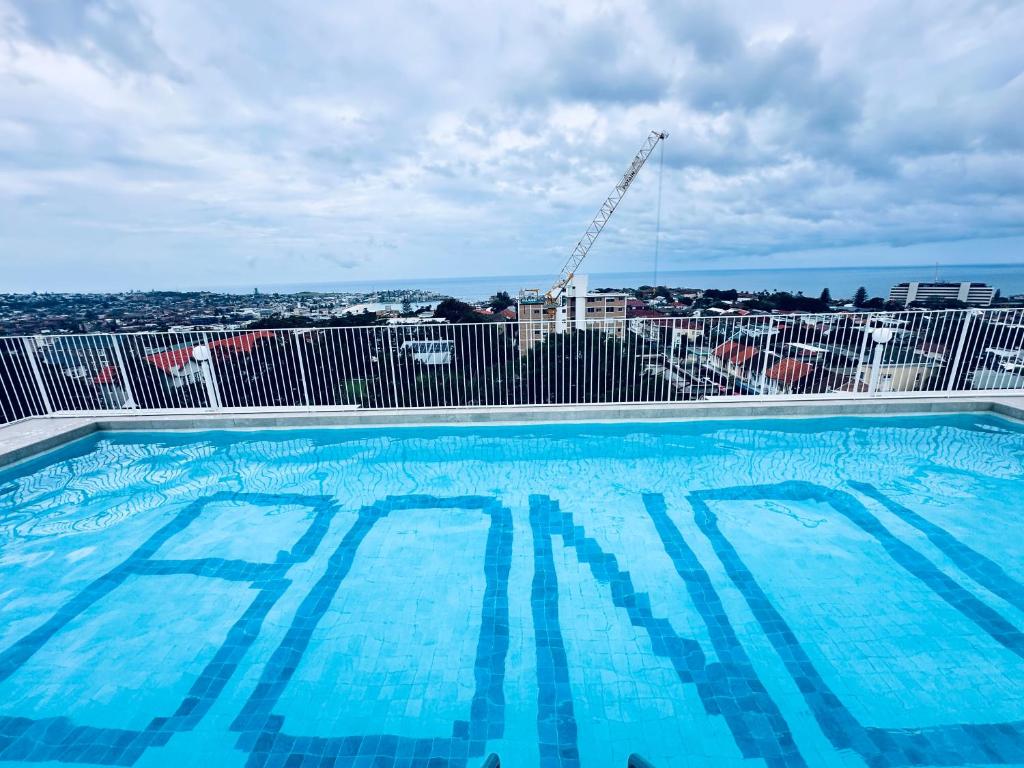 a large swimming pool on top of a building at HolidayRento Bondi Rooftop Pool & Air Con Studio in Sydney