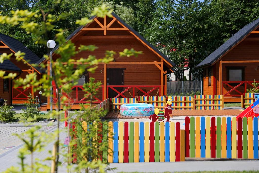 a model of a house with a fence in front of it at Rozewska Bliza Domki Letniskowe in Jastrzębia Góra