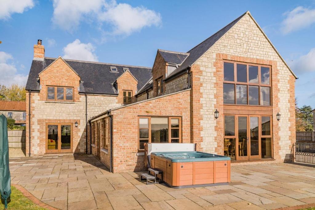 a large brick house with a pool in a courtyard at 5 Bed in Langport oc-h33495 in Langport